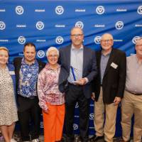 Peter Riemersma smiles with his award and his supporters